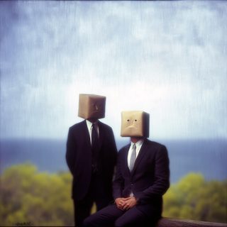 Two figures with paper-bag faces seated together by the sea.