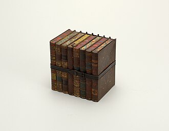 a printed tin biscuit box, lithographed panels on its sides, lid seated