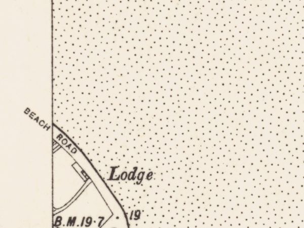 The same unbroken stipple field the strand shares between two episodes, Beach Road at its edge