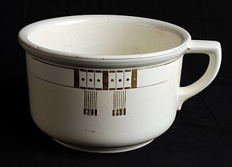 a glazed earthenware chamber pot, single loop handle, a band of colour at the rim